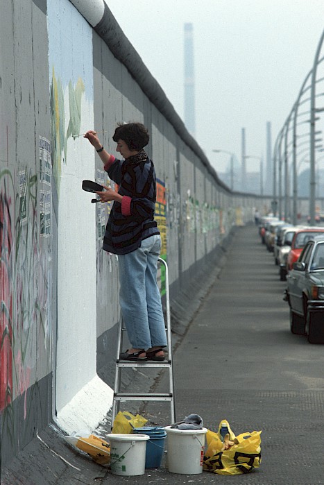 Muriel Raoux vor ihrem Bild an der Berliner Mauer, 1990